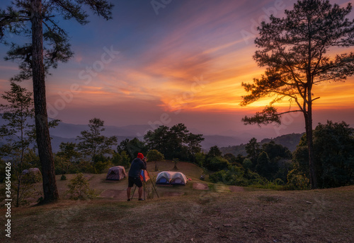 Asian man take picture sunset viewpoint at Huai Nam Dang National Park, Thailand