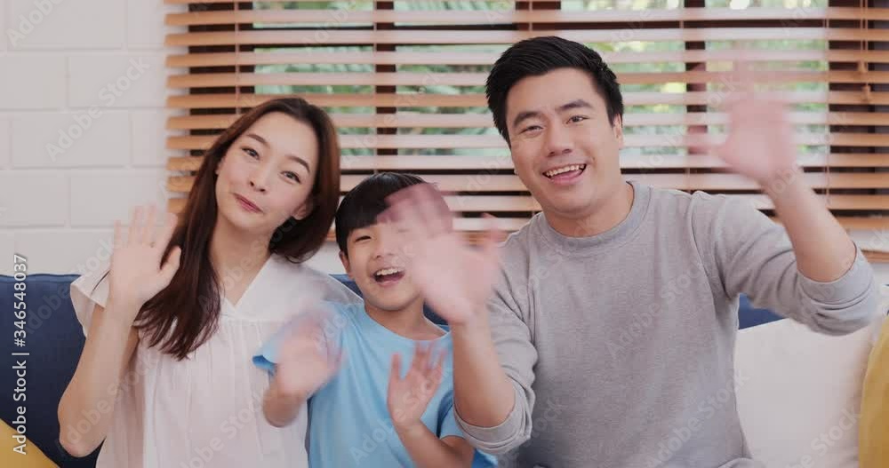 Cheerful asian family looking to camera and talking at living room. They record video call together with happy emotion. Leisure, Lifestyle, Holidays and Family concept. Cheerful asian family looking to camera and talking at living room. They record video call together with happy emotion. Leisure, Lifestyle, Holidays and Family concept.