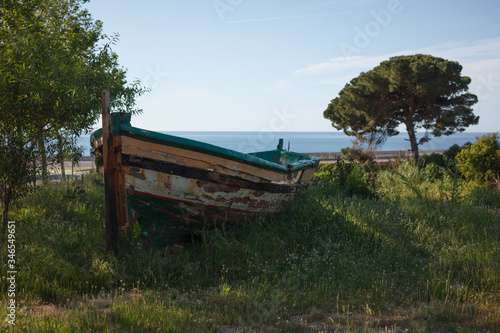 An old fishing boat on the shore.