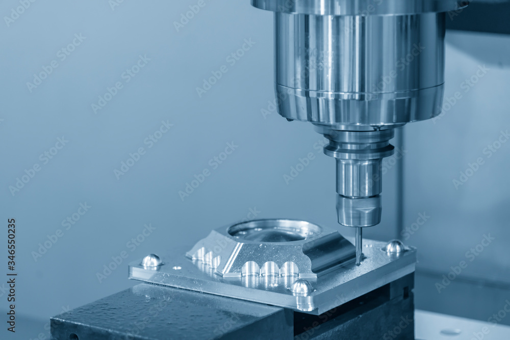 The CNC milling machine cutting the mold parts by solid endmill tool. The hi-technology mold and die manufacturing concept by machining center. The CNC milling machine cutting the mold parts by solid endmill tool. The hi-technology mold and die manufacturing concept by machining center.