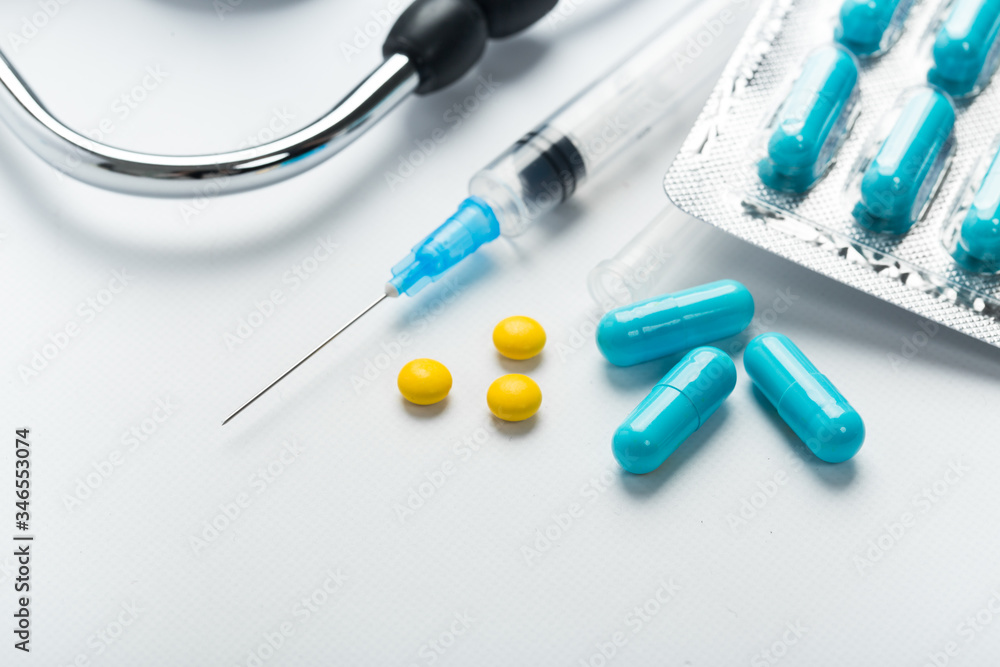 Capsule pills and syringe vaccine concept Capsule pills and syringe vaccine concept