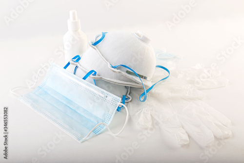 Protective respirator designed to filter viruses in the air, face mask and medical gloves on a white background.