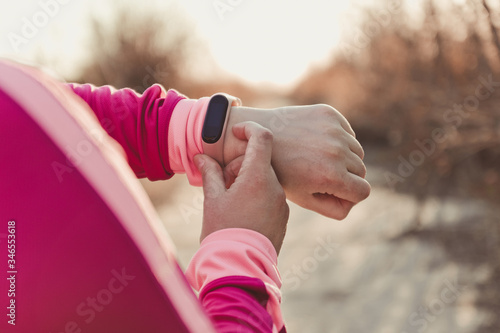 Obraz na plátne Healthy lifestyle concept of female hand with fitness bracelet tracker before jo