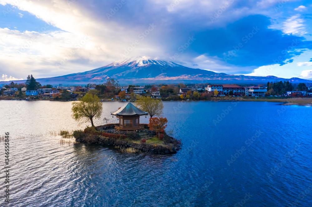 Japan. Kawaguchiko lake with a quadcopter. Japanese-style gazebo on a small island. Mount Fuji. Clouds cover the top of the fuji. Fuji volcano on an autumn day. Japanese landscape. Guide.