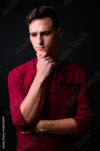 Portrait of young businessman thinking and looking down