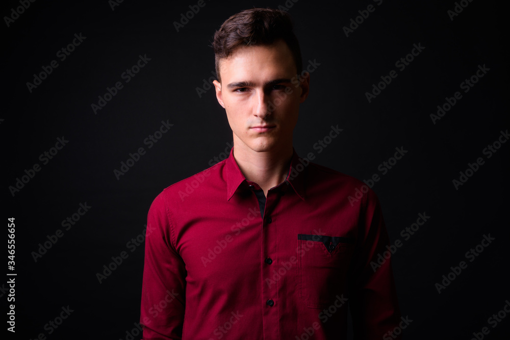 Portrait of young handsome businessman looking at camera