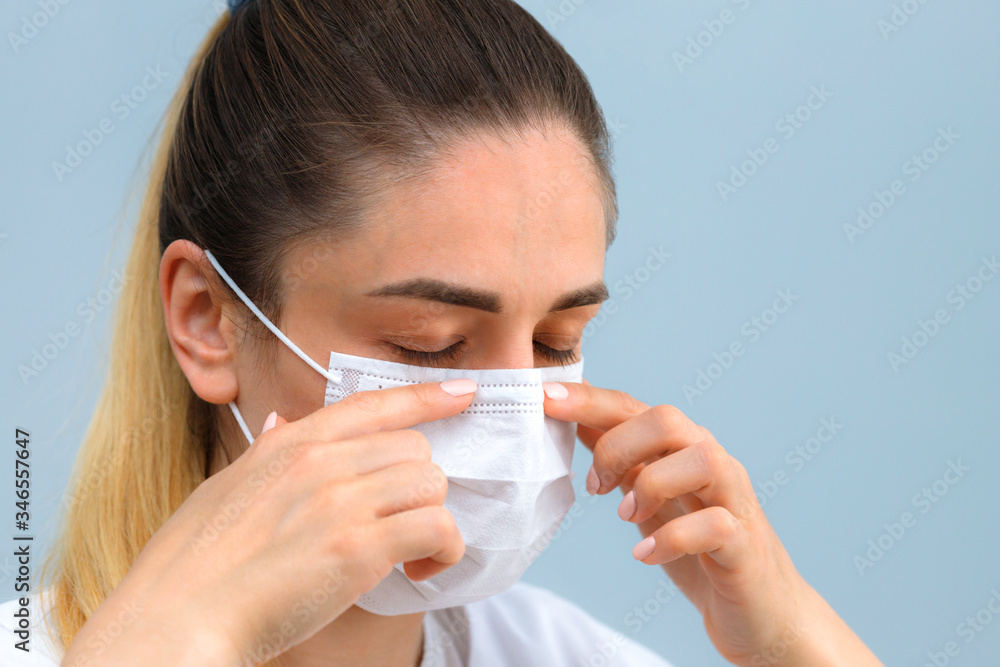 Instruction, how to wear the medical protective mask. Girl wears medical mask. Step 4. Instruction, how to wear the medical protective mask. Girl wears medical mask. Step 4.