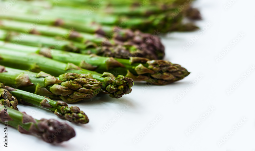 Bunch of fresh raw asparagus on white background, vegetarian concept. Green grass sparrowgrass sticks, food for veggie. Bunch of fresh raw asparagus on white background, vegetarian concept. Green grass sparrowgrass sticks, food for veggie.
