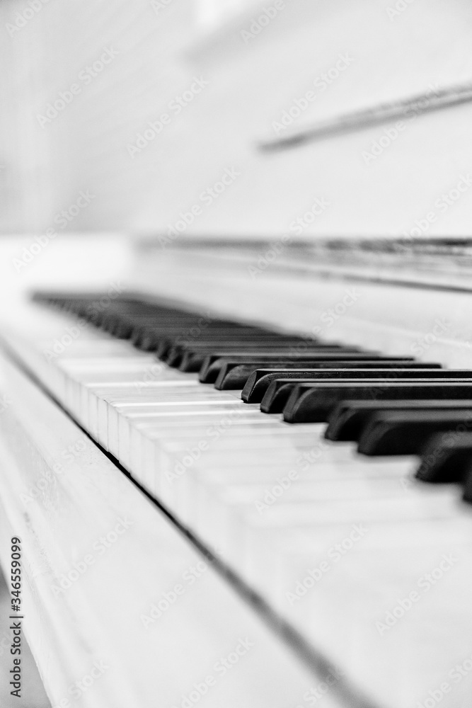 Close up white piano keyboard. Music instrument. Black and white key. Play sound, chord, melody. Classical, musical art. Jazz performance, entertainment. Musician background. Classic note harmony. Close up white piano keyboard. Music instrument. Black and white key. Play sound, chord, melody. Classical, musical art. Jazz performance, entertainment. Musician background. Classic note harmony.