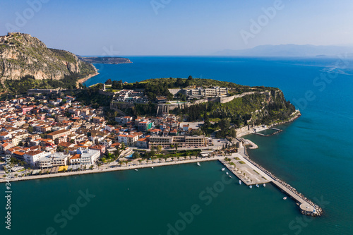 Fototapeta Naklejka Na Ścianę i Meble -  Green peninsula with Nafplion city in Greece from above with blue Mediterranean sea, old town roofs and small port