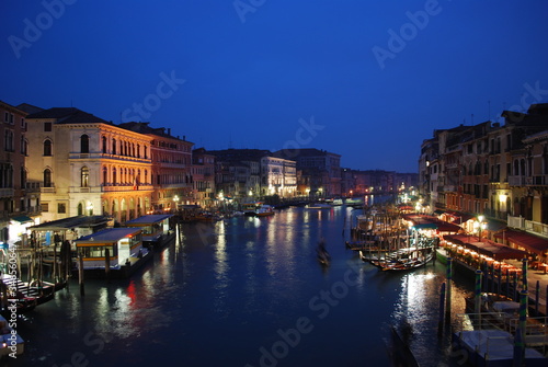 Boats Moored In River In Front Of Illuminated City At Night © stefano della gatta/EyeEm