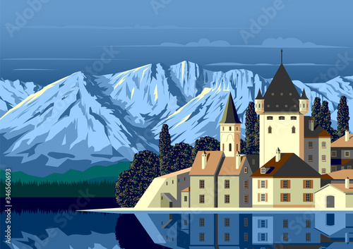 Alpine landscape with a medieval castle in the first plan, a lake and mountains in the background.