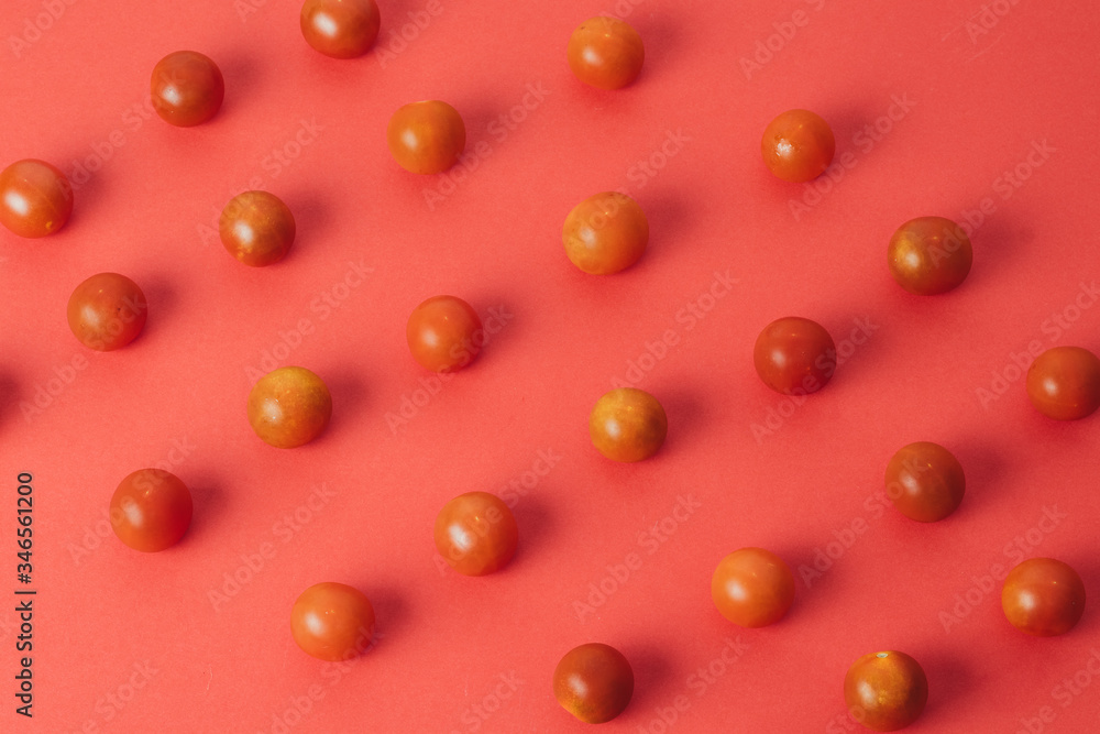 Colorful pattern of cherry tomatoes on red background. Top view Colorful pattern of cherry tomatoes on red background. Top view