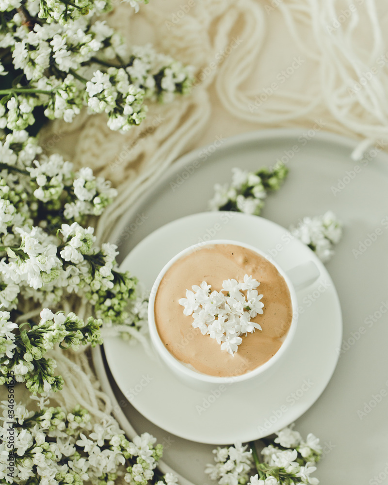 Composition with the branches of lilac and fresh coffee with foam in white cup. Relax time, pay yourself first/ Composition with the branches of lilac and fresh coffee with foam in white cup. Relax time, pay yourself first/
