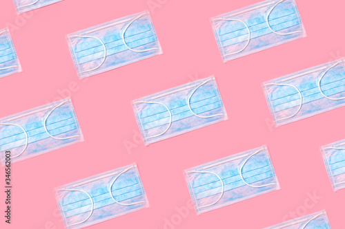 many blue masks on a pink background