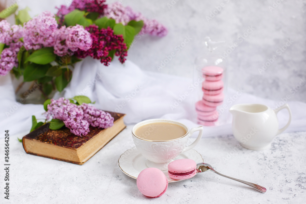 postcard good morning. a Cup of coffee , a branch of lilac, macaroons, old books .