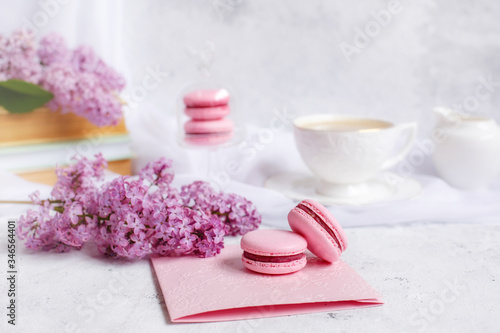 postcard good morning. a Cup of coffee , a branch of lilac, macaroons, old books .