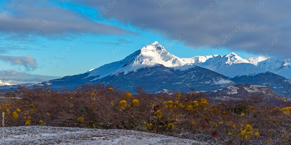 Panorama landscape with an illuminated peak of the Torres del Paine massif at sunrise in winter, Torres del Paine national park, Patagonia, Chile.