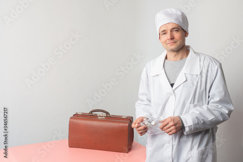 A doctor in a white coat wi...