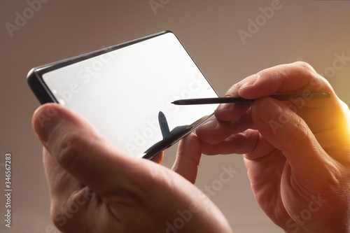 Fototapet Smartphone and stylus close-up