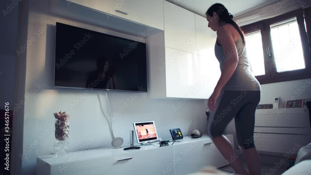 Woman making step gym workout at home in coronavirus time Woman making step gym workout at home in coronavirus time