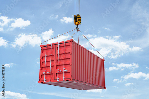 3d rendering of closed red shipping container suspended from crane against blue sky with white clouds. photo