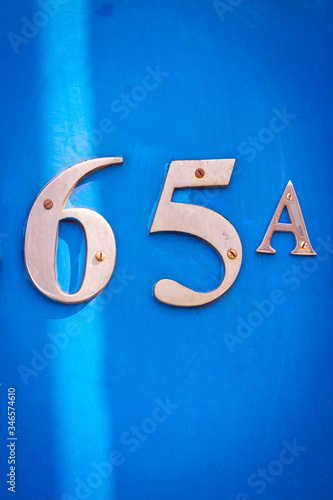 House number 65A on a blue wooden front door