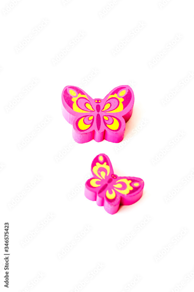 Wooden figure for children to play with. The butterfly shape. Butterfly made of pink wood