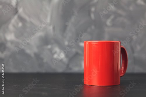 Photos Red cup gray background ron black table. Copy space