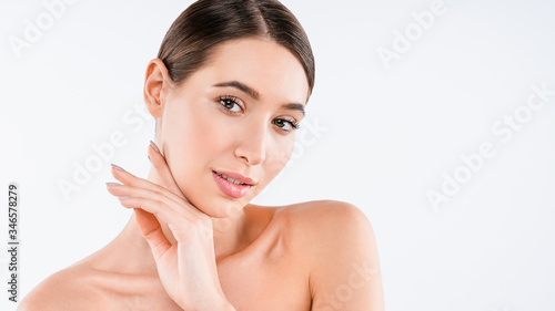 Portrait of young half naked woman with perfect skin looking at camera isolated over white background