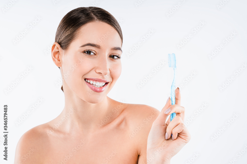 Beauty portrait of cheerful half naked woman holding toothbrush isolated over white background Beauty portrait of cheerful half naked woman holding toothbrush isolated over white background