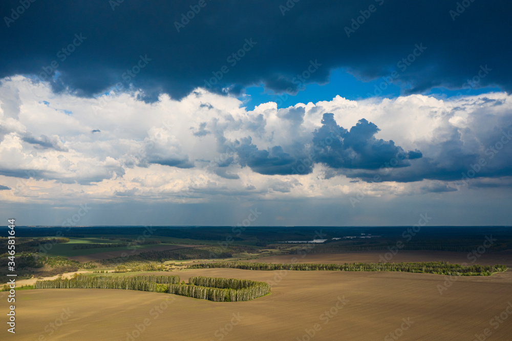 Storm clouds over agricultural fields in the countryside.