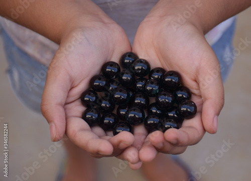 Close up of Glass Marbles in hands also called as Kancha in Hindi Language photo