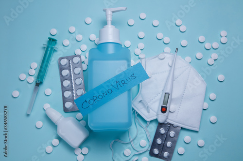 Antivirus concept. Mask, pills, sanitizer, syringe, thermometer