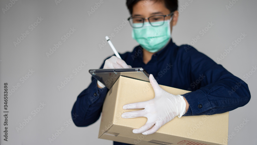 Signing to paper box package. Smiling young delivery man holding a cardboard box. The employee man putting signature in clipboard
Signing to paper box package. Smiling young delivery man holding a cardboard box. The employee man putting signature in clipboard