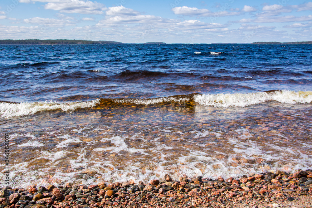View of the stormy Lake Saimaa and stony shore, Kylaniemi island, Finland View of the stormy Lake Saimaa and stony shore, Kylaniemi island, Finland