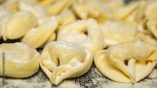 Close up to delicious tortellini a ring-shaped pasta from Italy. Traditionally they are stuffed with a mix of meat, parmigiano reggiano cheese, egg and nutmeg