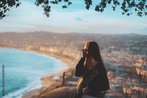 young female watching sunset in Nice, France. beautiful panoramic aerial cityscape top view of Nice, of French riviera. Landscape of harbor, town of Cote d'Azur France. woman enjoying evening near sea