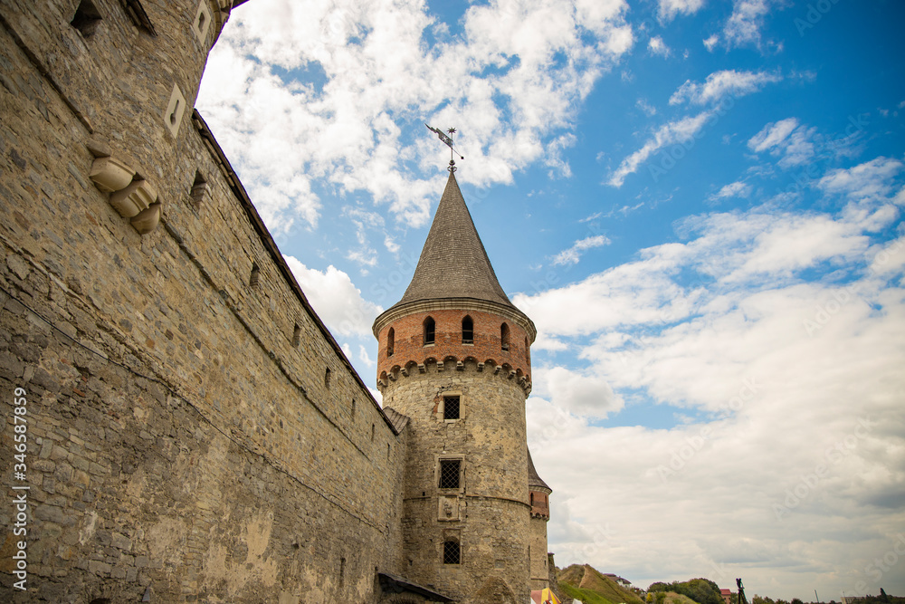 castle tower stone old medieval architecture heritage object exterior shape foreshortening from the close above point in clear weather summer day time in June, Eastern Europe