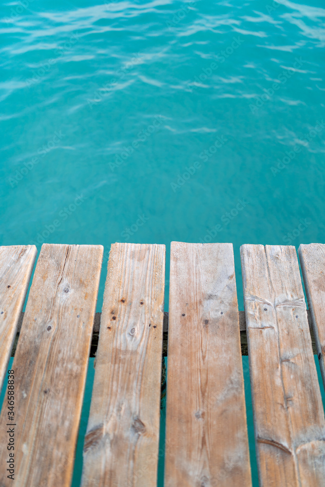 Wooden dock texture with blue turquoise water in tropical island