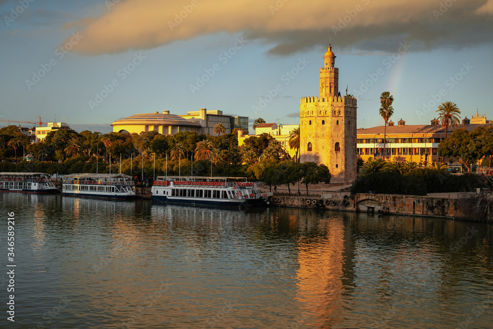 Fototapeta premium Beautiful tower of gold and Guadalquivir river at sunset in Seville, Spain