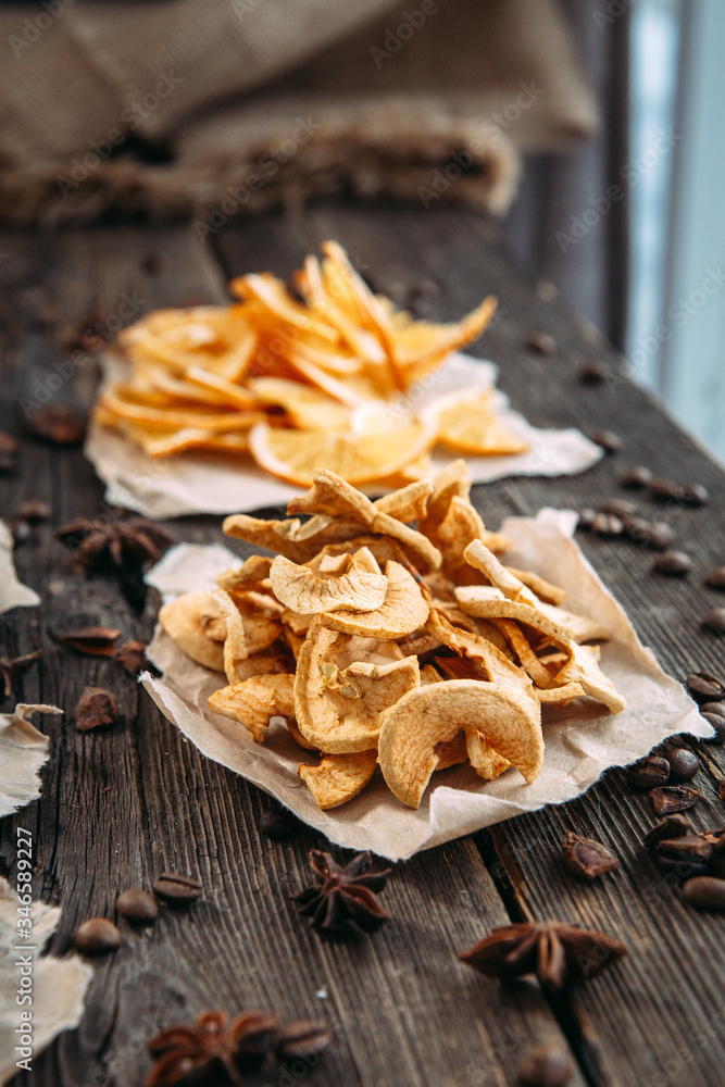 Fototapeta premium Dried slices of orange, apple, bananas and pear on paper