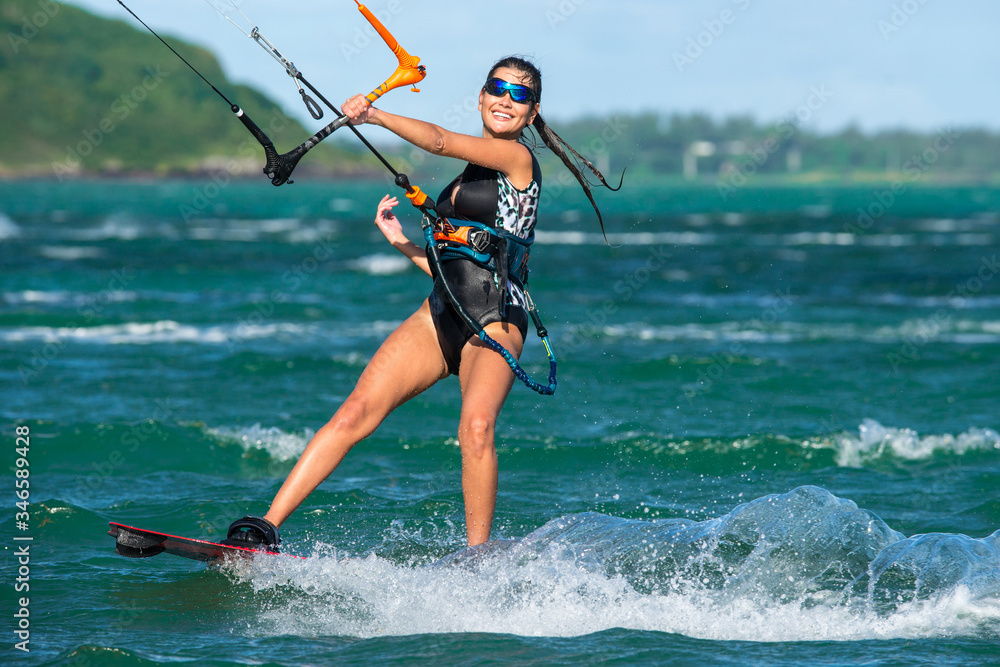 Beautiful girl with black hair kiting in the clear waters of the Indian Ocean. Mauritius Beautiful girl with black hair kiting in the clear waters of the Indian Ocean. Mauritius