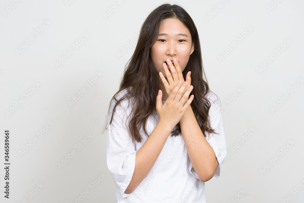 Portrait of young beautiful Asian woman looking shocked Portrait of young beautiful Asian woman looking shocked