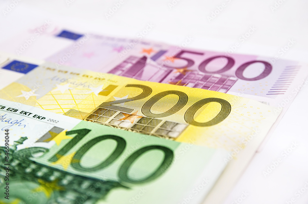 100, 200 and 500 euro banknotes on white. Close-up. Money background. 100, 200 and 500 euro banknotes on white. Close-up. Money background.