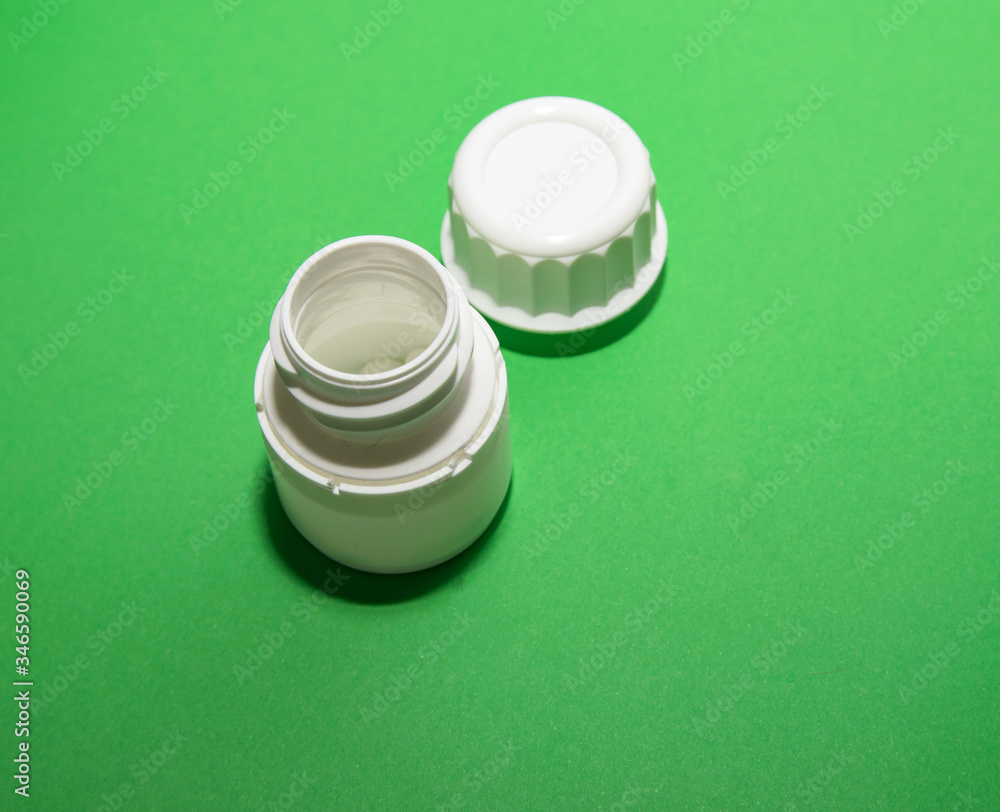 Step 3. A white jar of pills is open with a lid Step 3. A white jar of pills is open with a lid