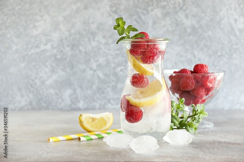 Raspberry infused water, coctail or lemonade. Summer iced cold drink with raspberry, lemon and mint. Selective focus