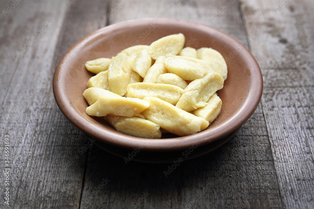 Dumplings. Potato and flour dumplings.
Appetizing dish on a wooden background. Dumplings. Potato and flour dumplings.
Appetizing dish on a wooden background.