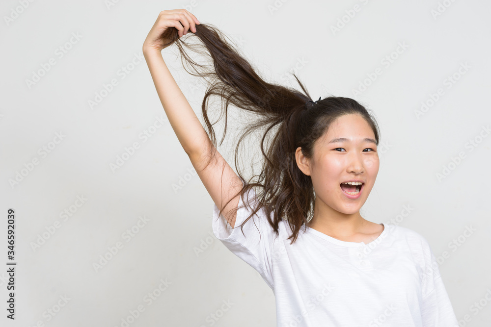 Portrait of happy young beautiful Asian woman with hair tied Portrait of happy young beautiful Asian woman with hair tied
