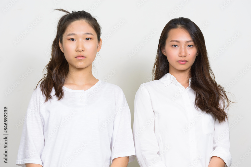 Two young beautiful Asian women as friends together Two young beautiful Asian women as friends together